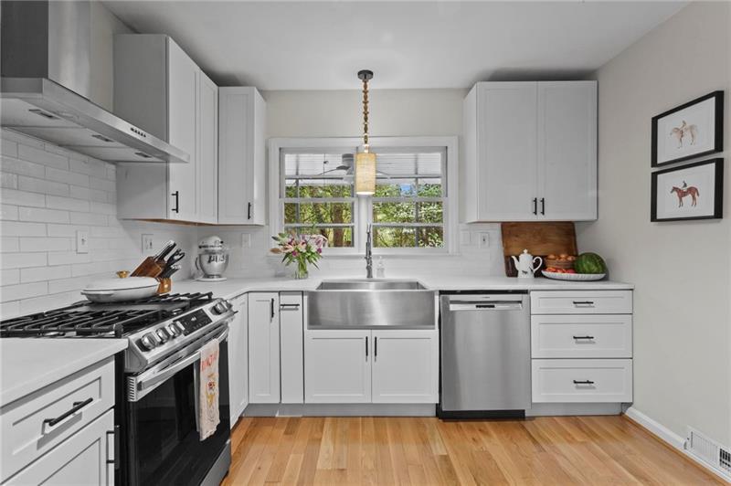 2333 Ferndale Drive Decatur, GA 30030 - Photo 12 of 30 a kitchen with granite countertop a stove and a wooden floor
