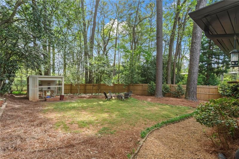 2333 Ferndale Drive Decatur, GA 30030 - Photo 26 of 30 a view of a backyard with couches and a table and chairs under an umbrella
