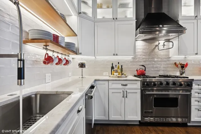 a kitchen with stainless steel appliances granite countertop a stove and a sink