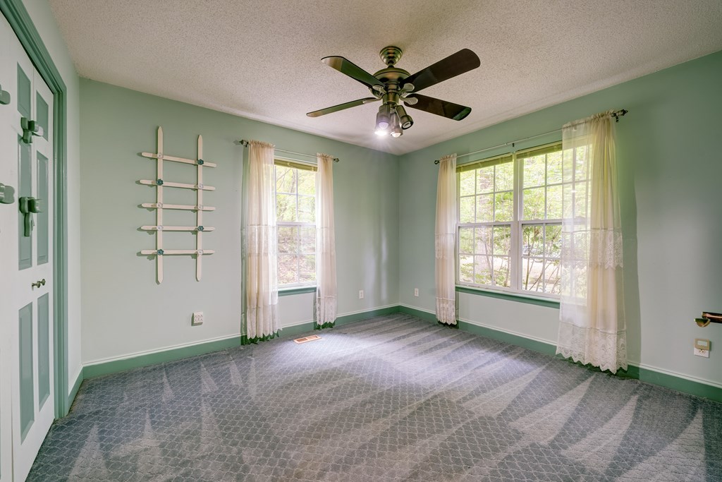 9327 Highway 52 Chatsworth, GA 30705 - Photo 29 of 43 a view of a livingroom with a ceiling fan and window
