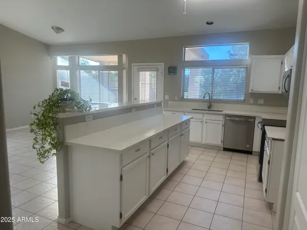 a kitchen with a sink stove and cabinets
