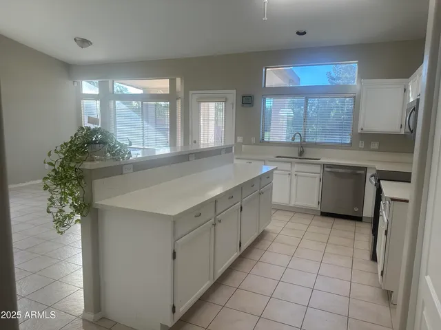 an empty room with a empty space and windows