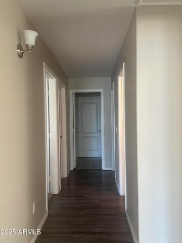 a backyard of a house with lots of green space and lake view in back