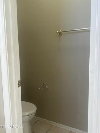 a bathroom with a granite countertop toilet and a shower