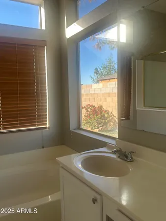 a bathroom with a sink a bathtub and window