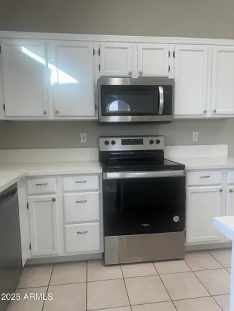 a stove top oven sitting inside of a kitchen