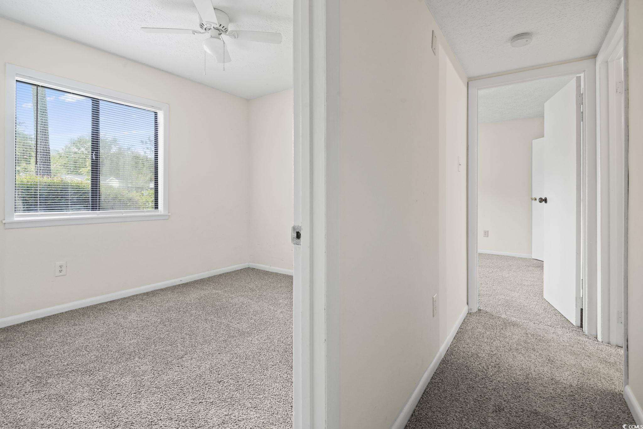 615 Carter Lane, Unit A1 Conway, SC 29526 - Photo 19 of 31 Corridor with a textured ceiling and light carpet