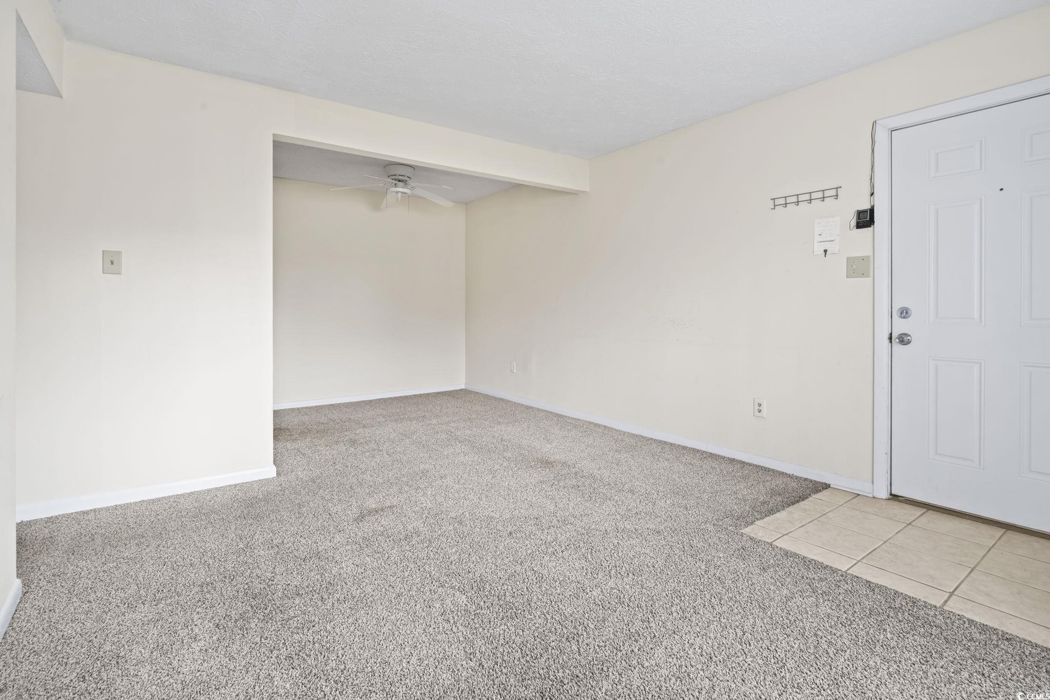 615 Carter Lane, Unit A1 Conway, SC 29526 - Photo 26 of 31 Unfurnished room featuring light carpet, ceiling fan, and light tile patterned floors