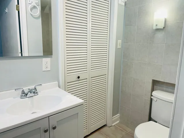 a bathroom with a sink a toilet and shower curtain