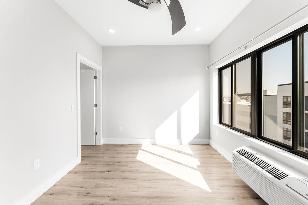 1 Flagship Street, Unit 208 Bayonne, NJ 07002 - Photo 11 of 32 a view of an empty room with wooden floor and a window