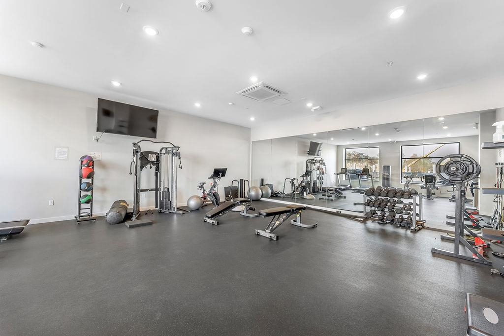 1 Flagship Street, Unit 208 Bayonne, NJ 07002 - Photo 25 of 32 a view of a room with gym equipment and a large mirror