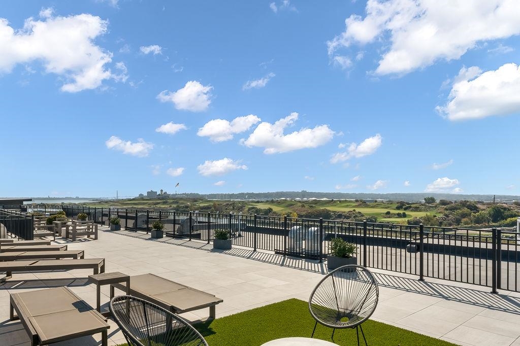 1 Flagship Street, Unit 208 Bayonne, NJ 07002 - Photo 31 of 32 a view of a terrace with lawn chairs and iron fence