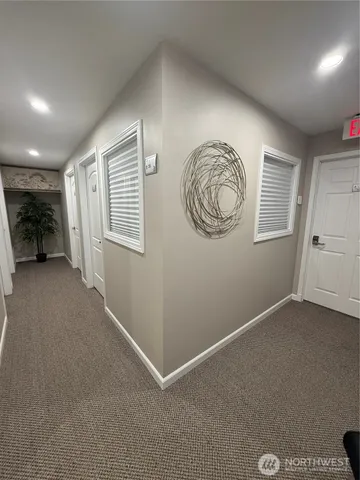 an empty room with closet and windows