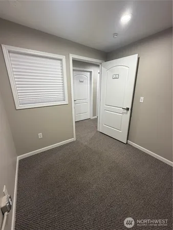 a view of a livingroom with an empty space and a window