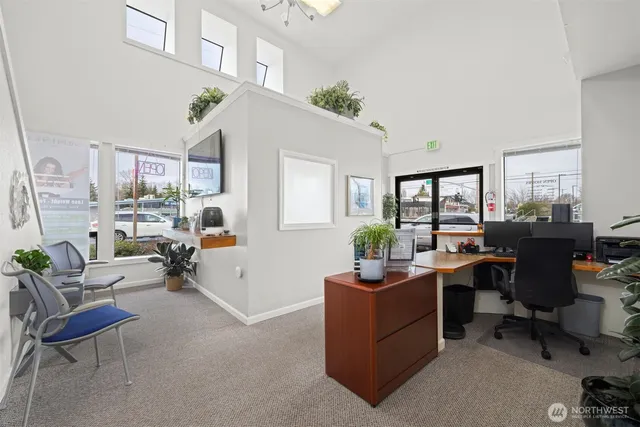 a view of a livingroom with workspace and a window