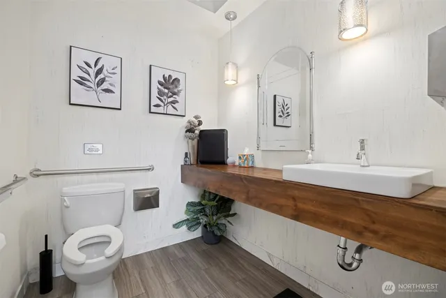 a bathroom with a sink mirror vanity and toilet