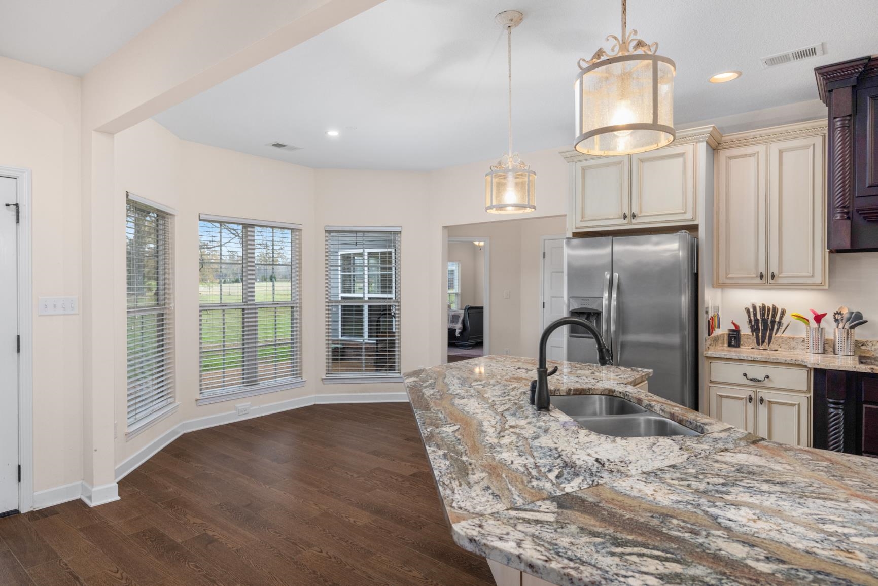 504 Bankston Road Nesbit, MS 38651 - Photo 13 of 39 Kitchen featuring an expansive island with a double basin sink, stone countertops, and a gooseneck faucet