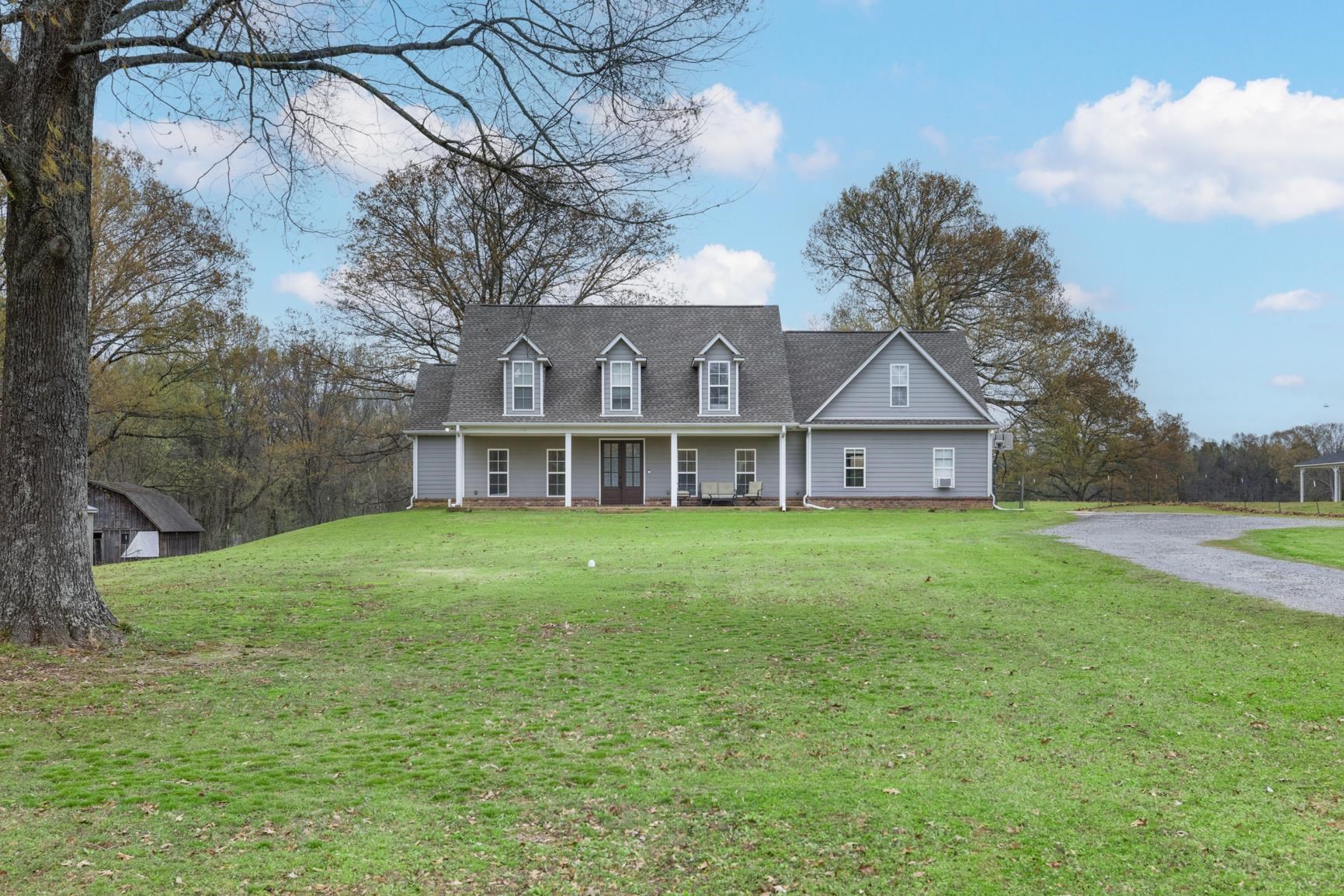 504 Bankston Road Nesbit, MS 38651 - Photo 2 of 39 Traditional-style home featuring light gray siding and a dormered roofline