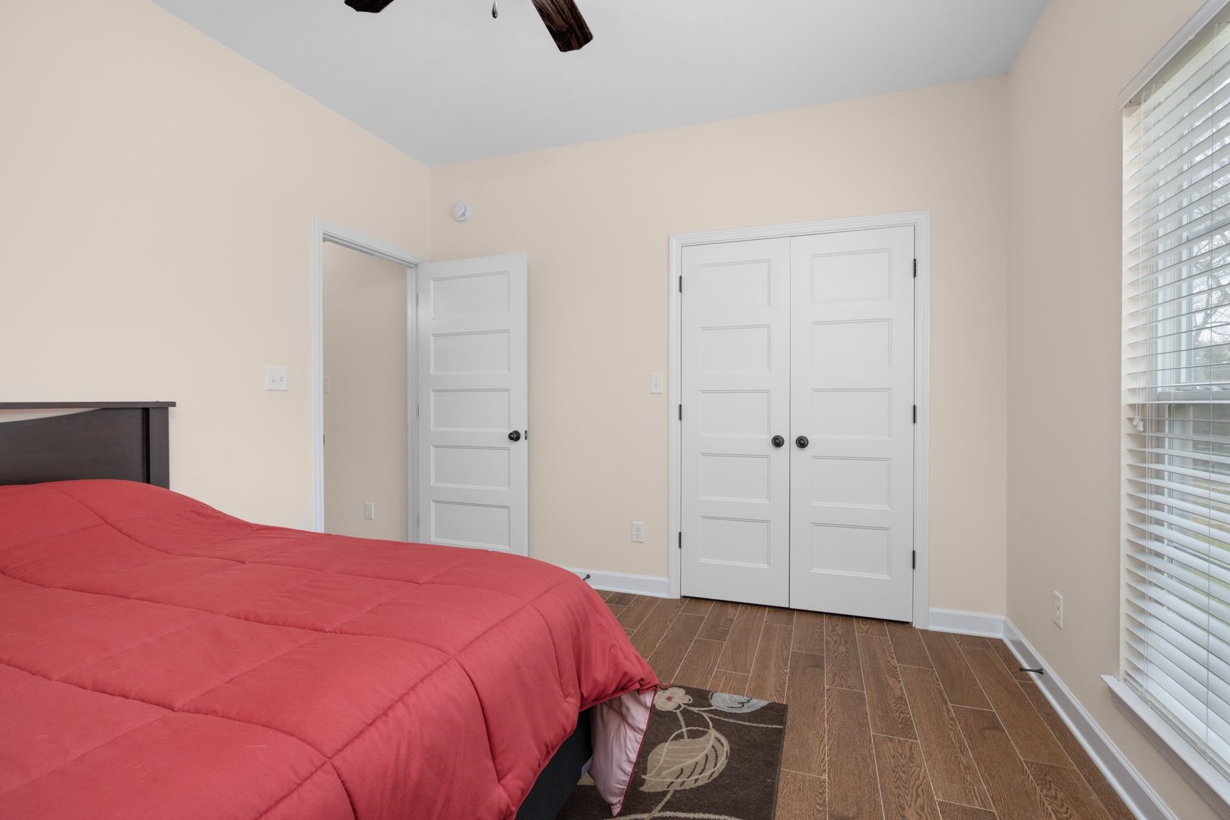 504 Bankston Road Nesbit, MS 38651 - Photo 21 of 39 Bedroom featuring wood-finish flooring, white panel doors, and a window with blinds