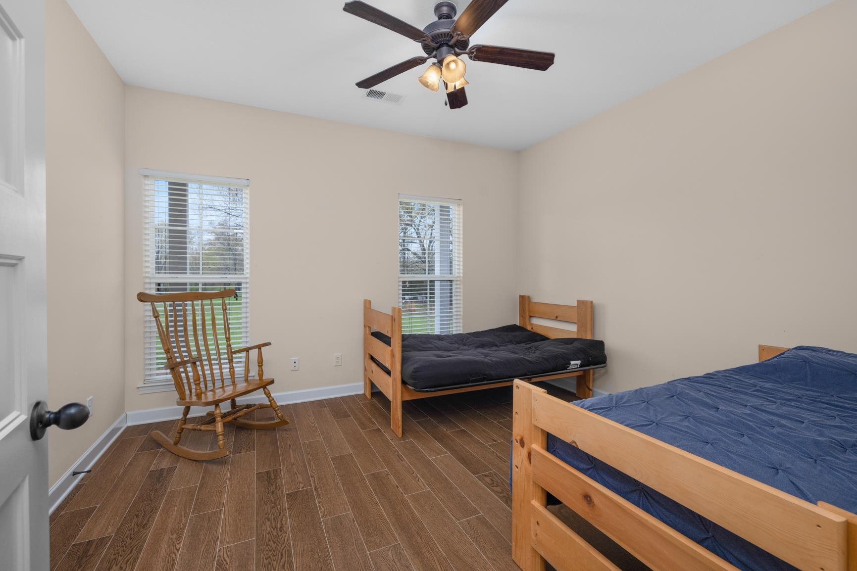 504 Bankston Road Nesbit, MS 38651 - Photo 25 of 39 Interior room featuring light beige walls, wood-finish flooring, and a ceiling fan with integrated lighting