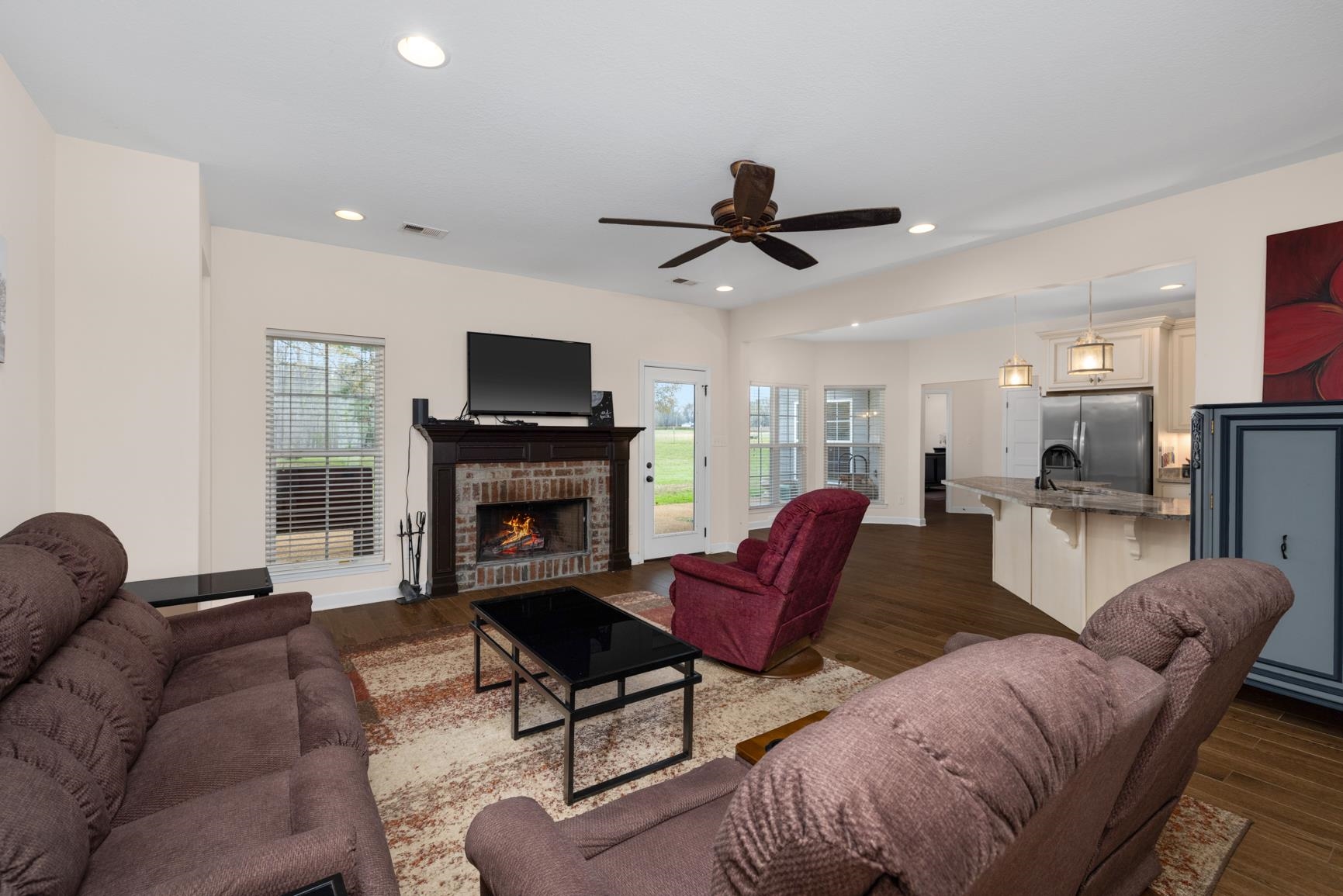 504 Bankston Road Nesbit, MS 38651 - Photo 9 of 39 Living area featuring a brick-surround fireplace with a dark wood mantel, recessed lighting, and a ceiling fan