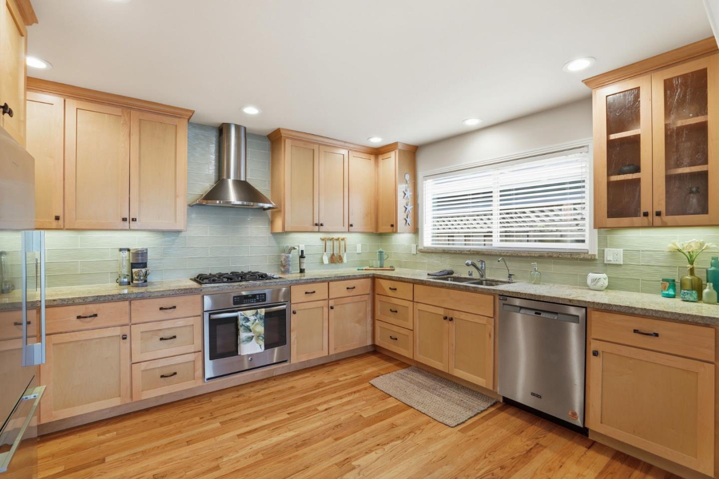 4570 Jewel Street Capitola, CA 95010 - Photo 11 of 45 a kitchen with granite countertop white cabinets and white appliances