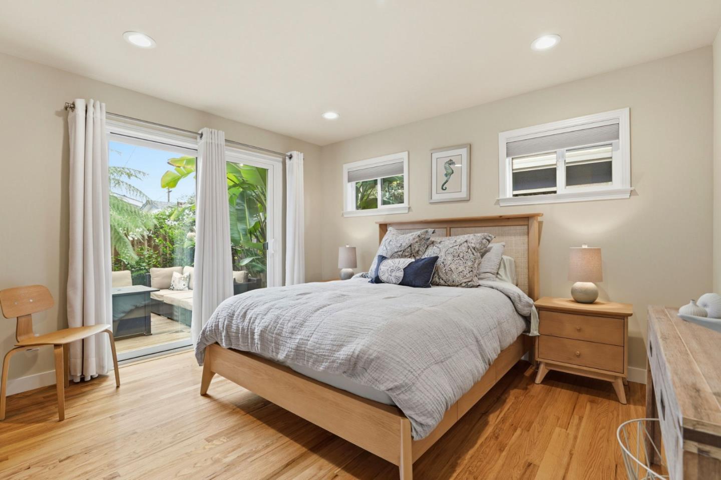 4570 Jewel Street Capitola, CA 95010 - Photo 19 of 45 a bedroom with a bed wooden floor and a large window