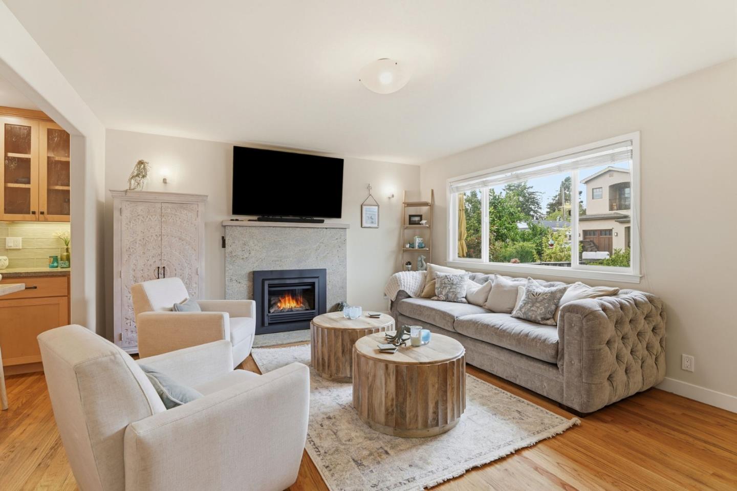 4570 Jewel Street Capitola, CA 95010 - Photo 10 of 45 a living room with furniture a flat screen tv and a fireplace