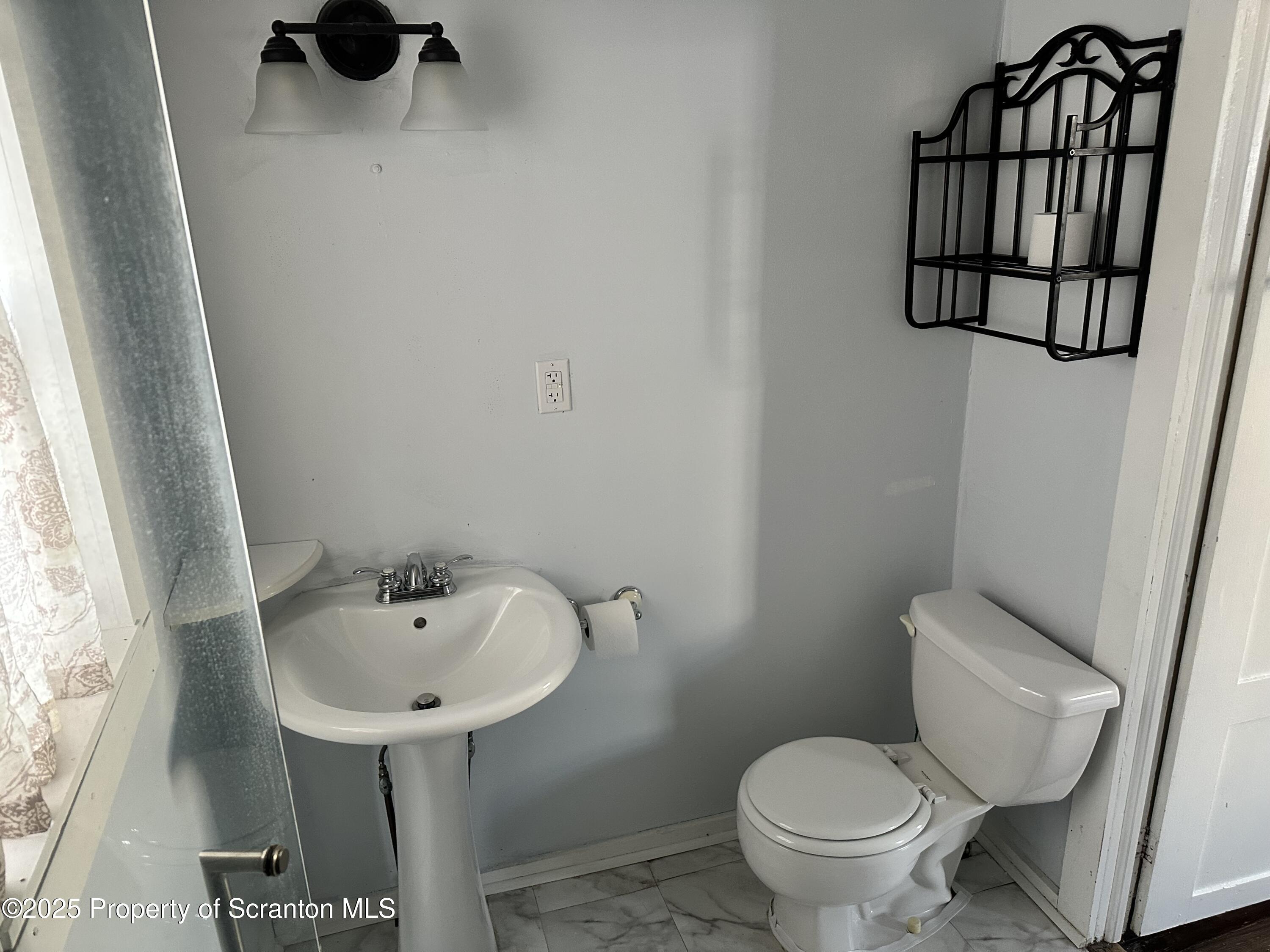 1108 North Abington Road Waverly, PA 18471 - Photo 20 of 32 a bathroom with a toilet sink and mirror