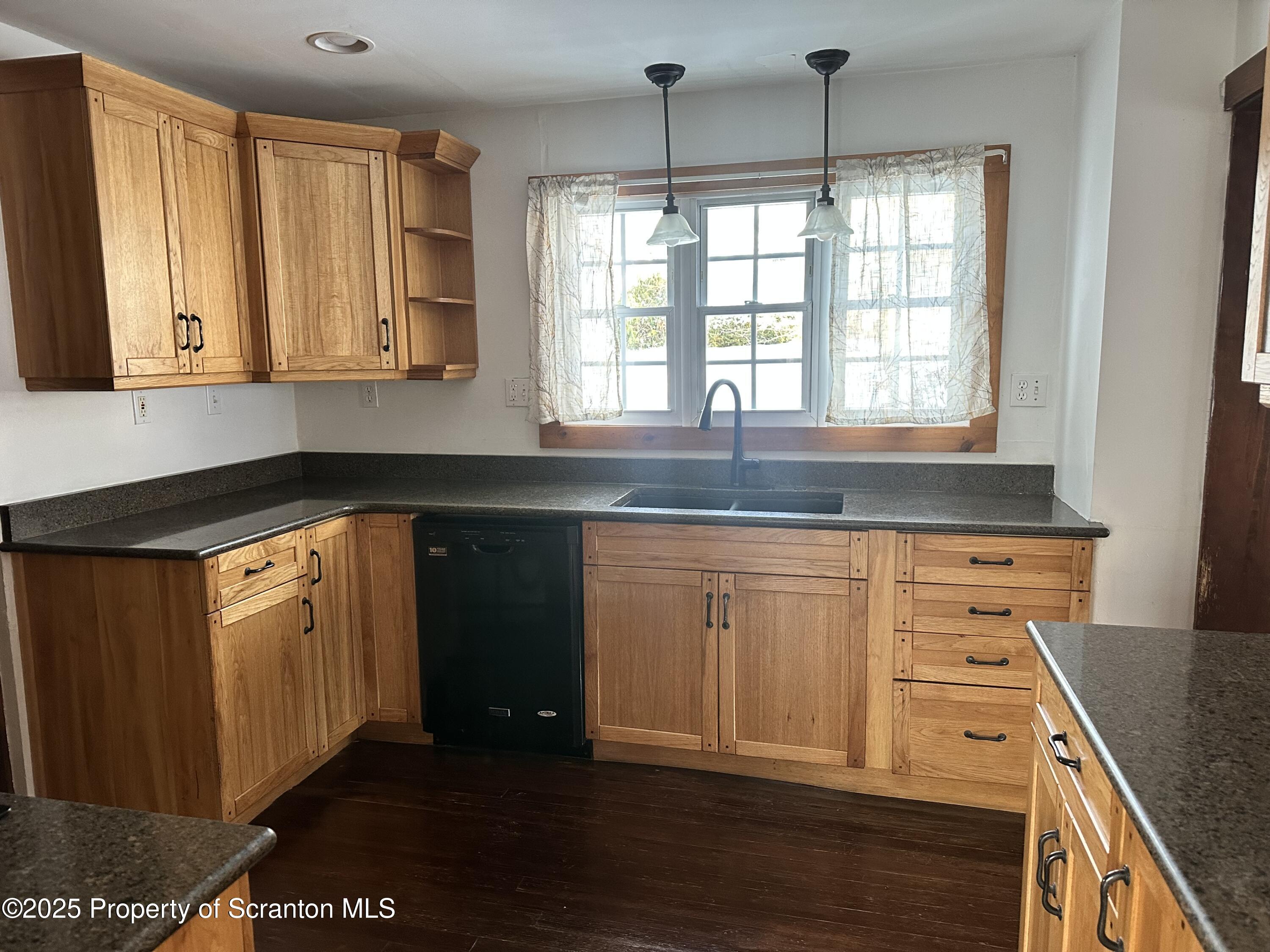 1108 North Abington Road Waverly, PA 18471 - Photo 25 of 32 a kitchen with granite countertop a sink window and cabinets