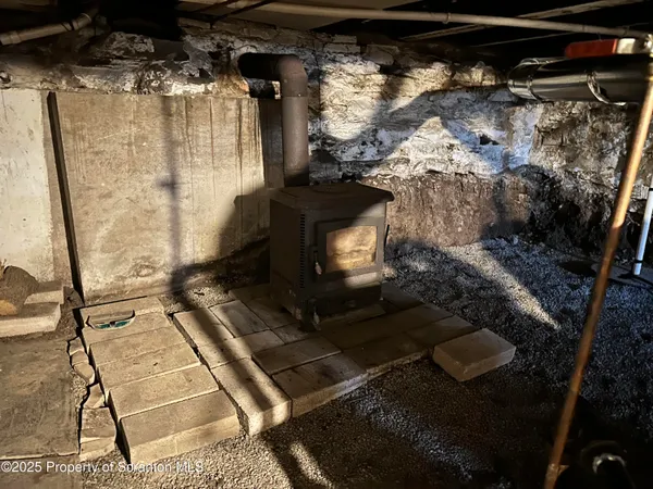 a living room with furniture large wooden floor and windows