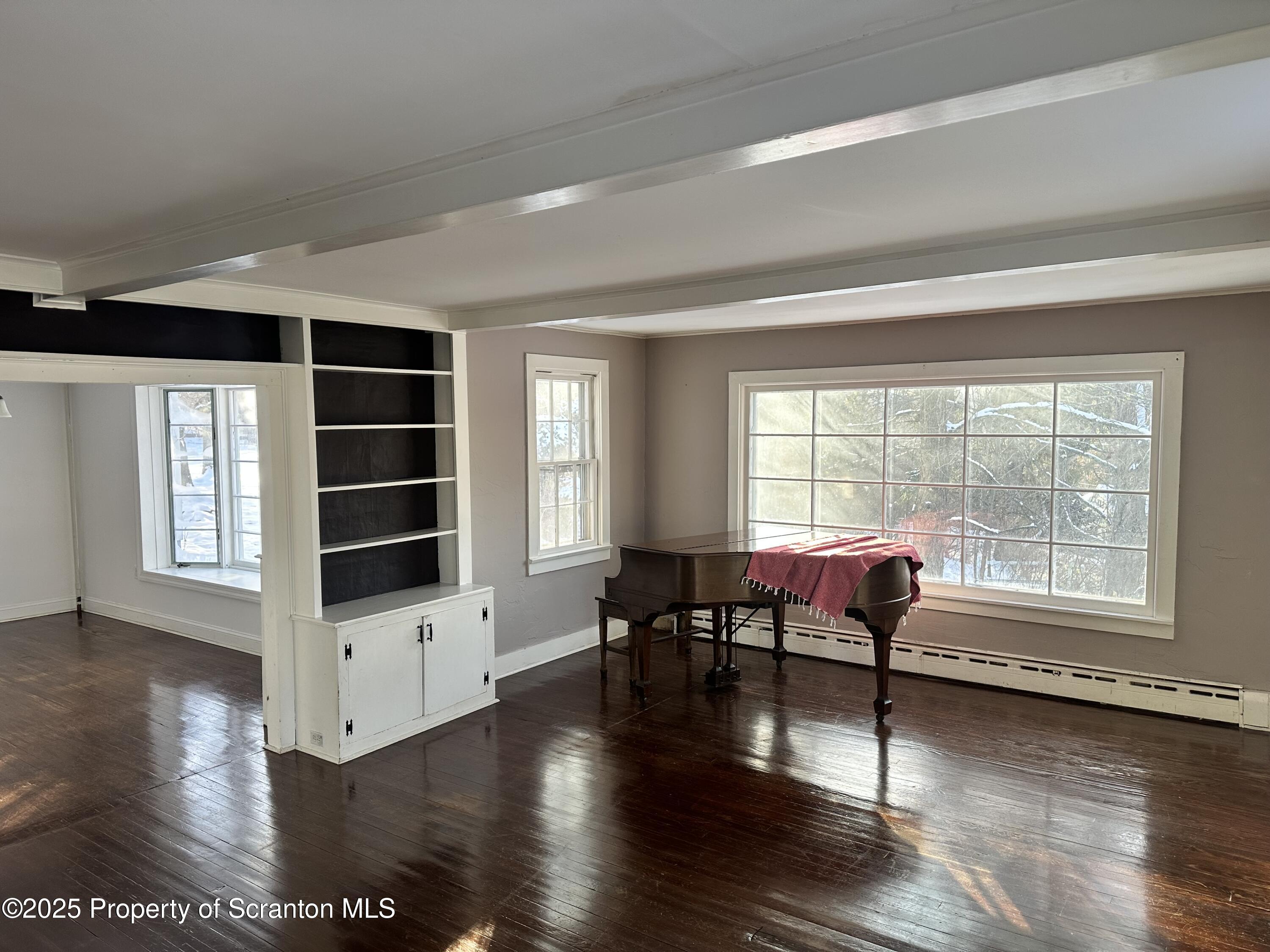 1108 North Abington Road Waverly, PA 18471 - Photo 30 of 32 a living room with furniture large wooden floor and windows