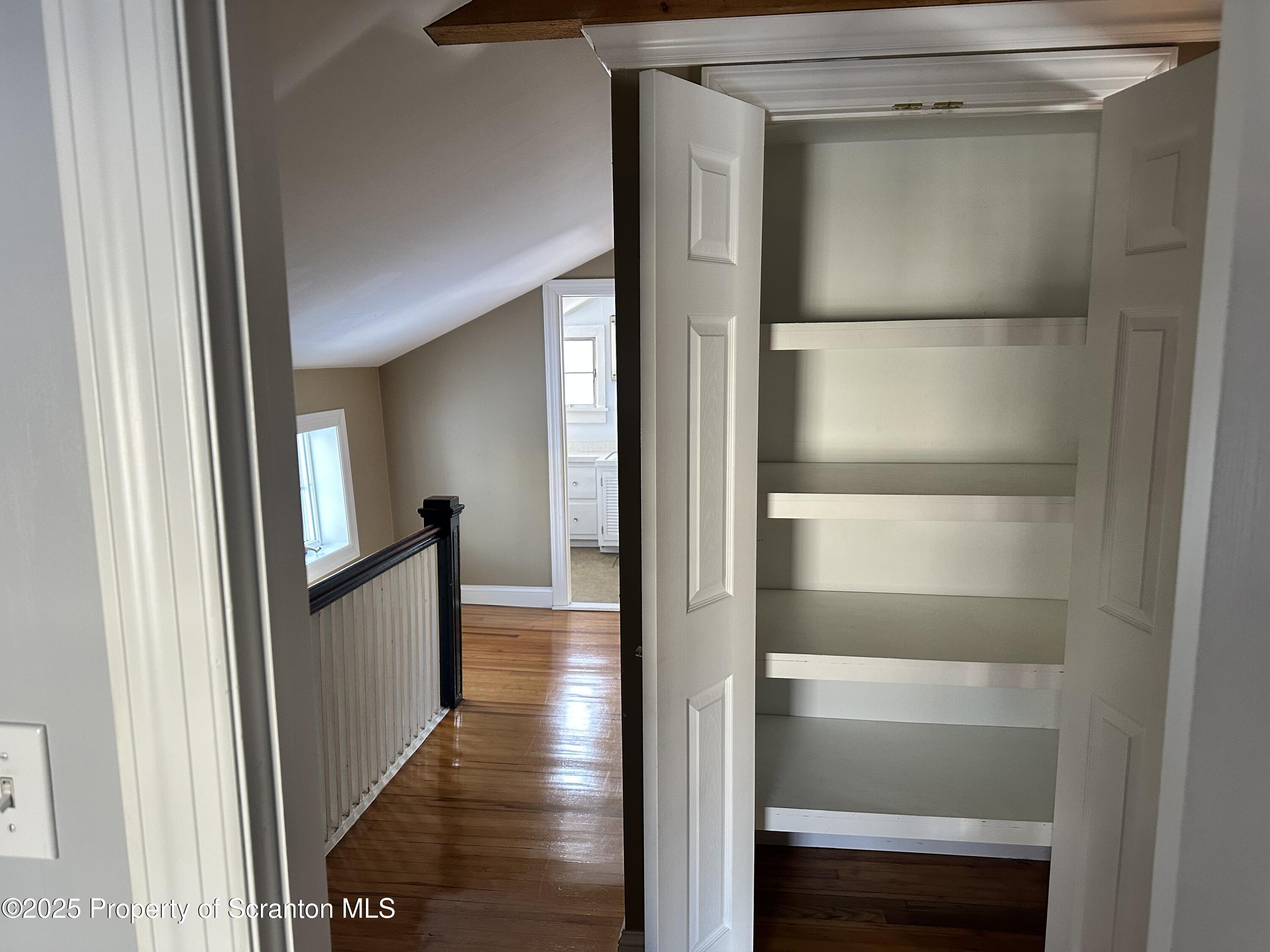 1108 North Abington Road Waverly, PA 18471 - Photo 10 of 32 a view of a hallway with wooden floor and entryway
