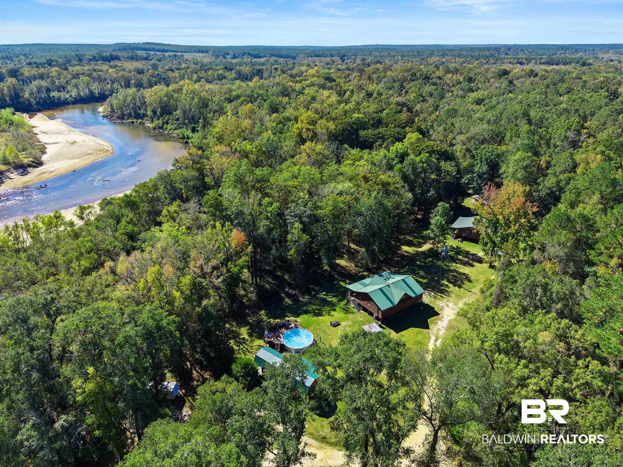 724 Rowell Lane Brewton, AL 36426 - Photo 1 of 40 Aerial overview of property's location with a heavily wooded area and a large body of water