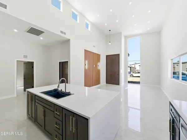a kitchen with stainless steel appliances a sink and a refrigerator