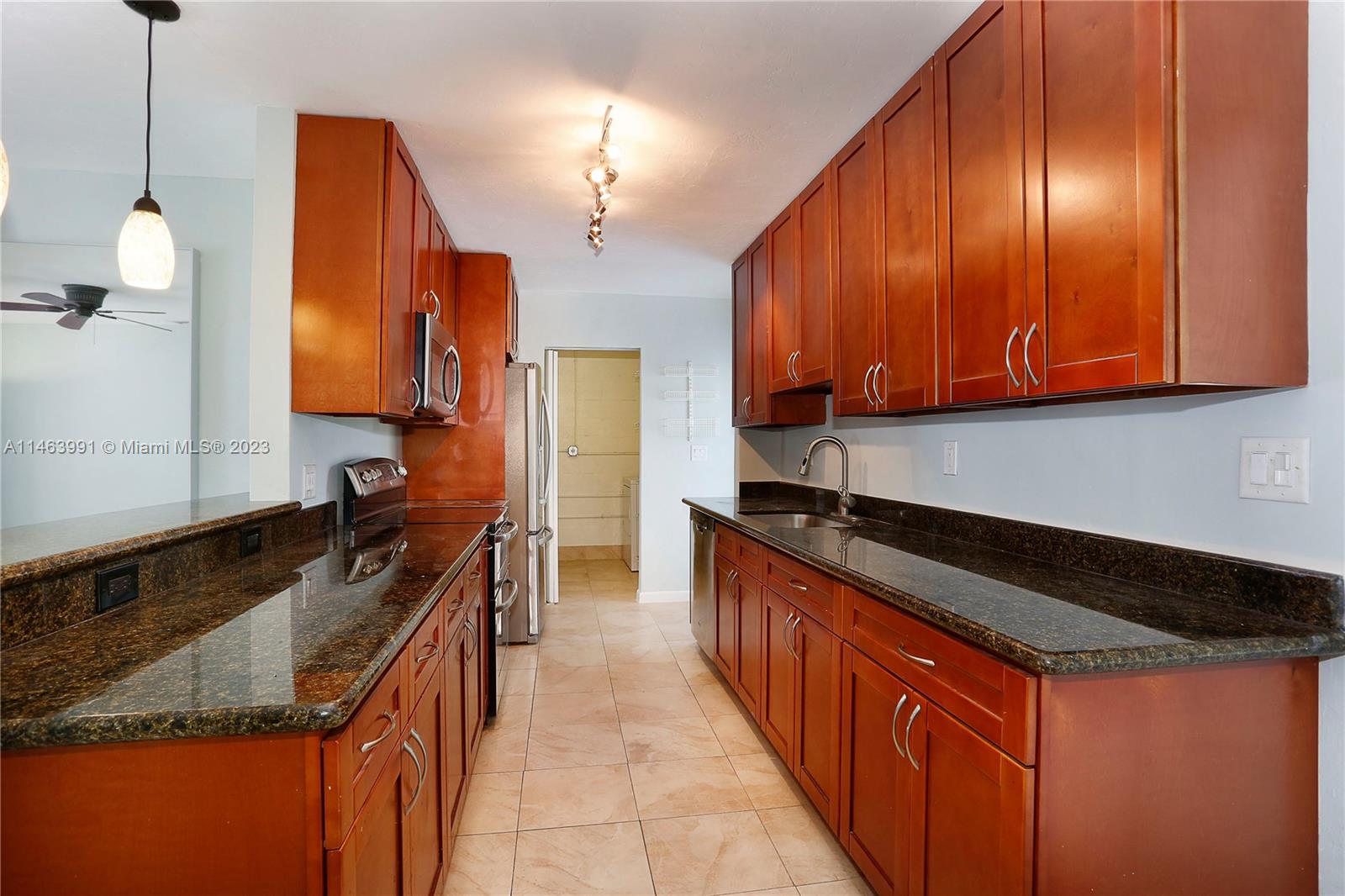 10045 Southwest 82nd Street Miami, FL 33173 - Photo 15 of 31 a kitchen with granite countertop a sink and a stove