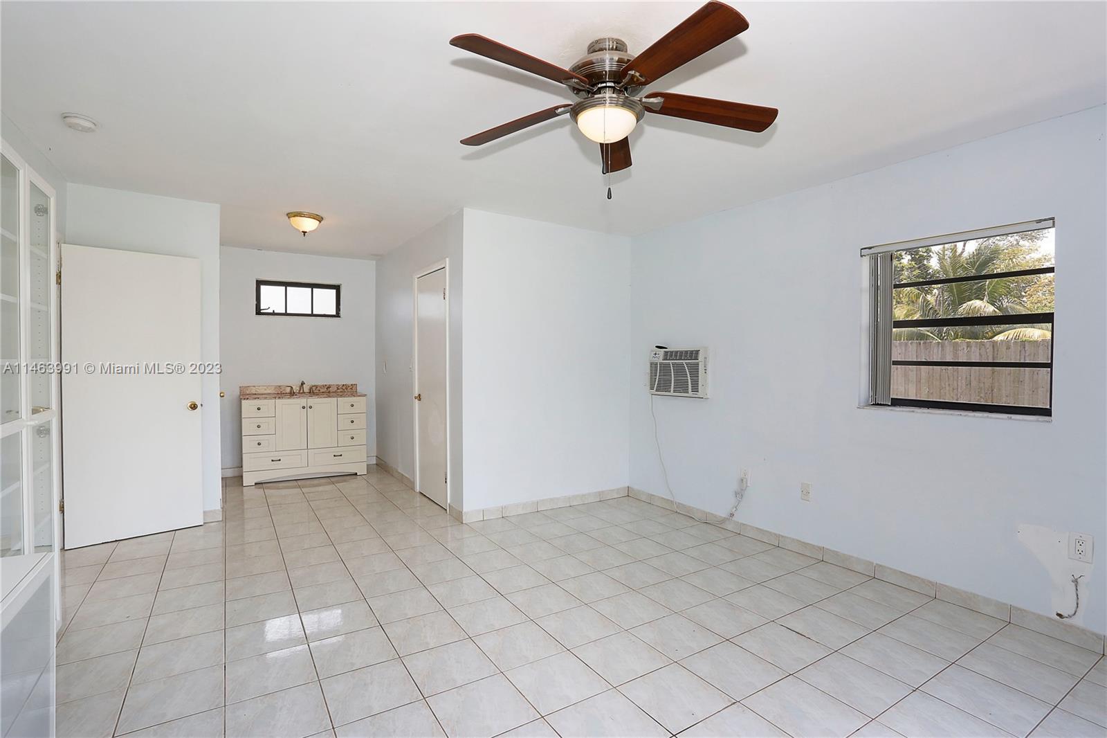 10045 Southwest 82nd Street Miami, FL 33173 - Photo 22 of 31 an empty room with closet and windows