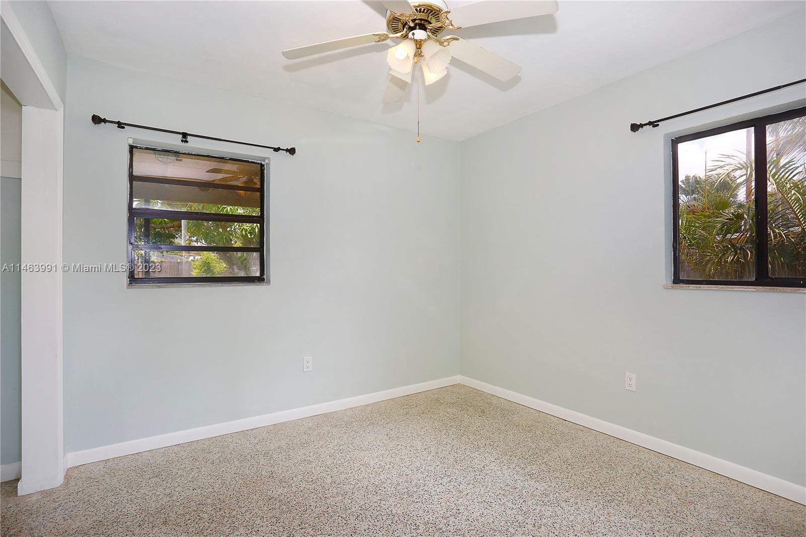 10045 Southwest 82nd Street Miami, FL 33173 - Photo 29 of 31 an empty room with a window and a fan