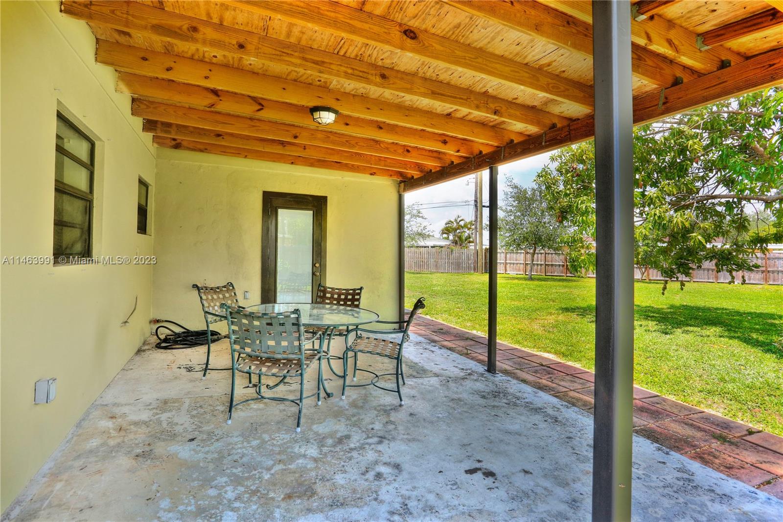 10045 Southwest 82nd Street Miami, FL 33173 - Photo 4 of 31 a view of a patio with a table chairs and backyard