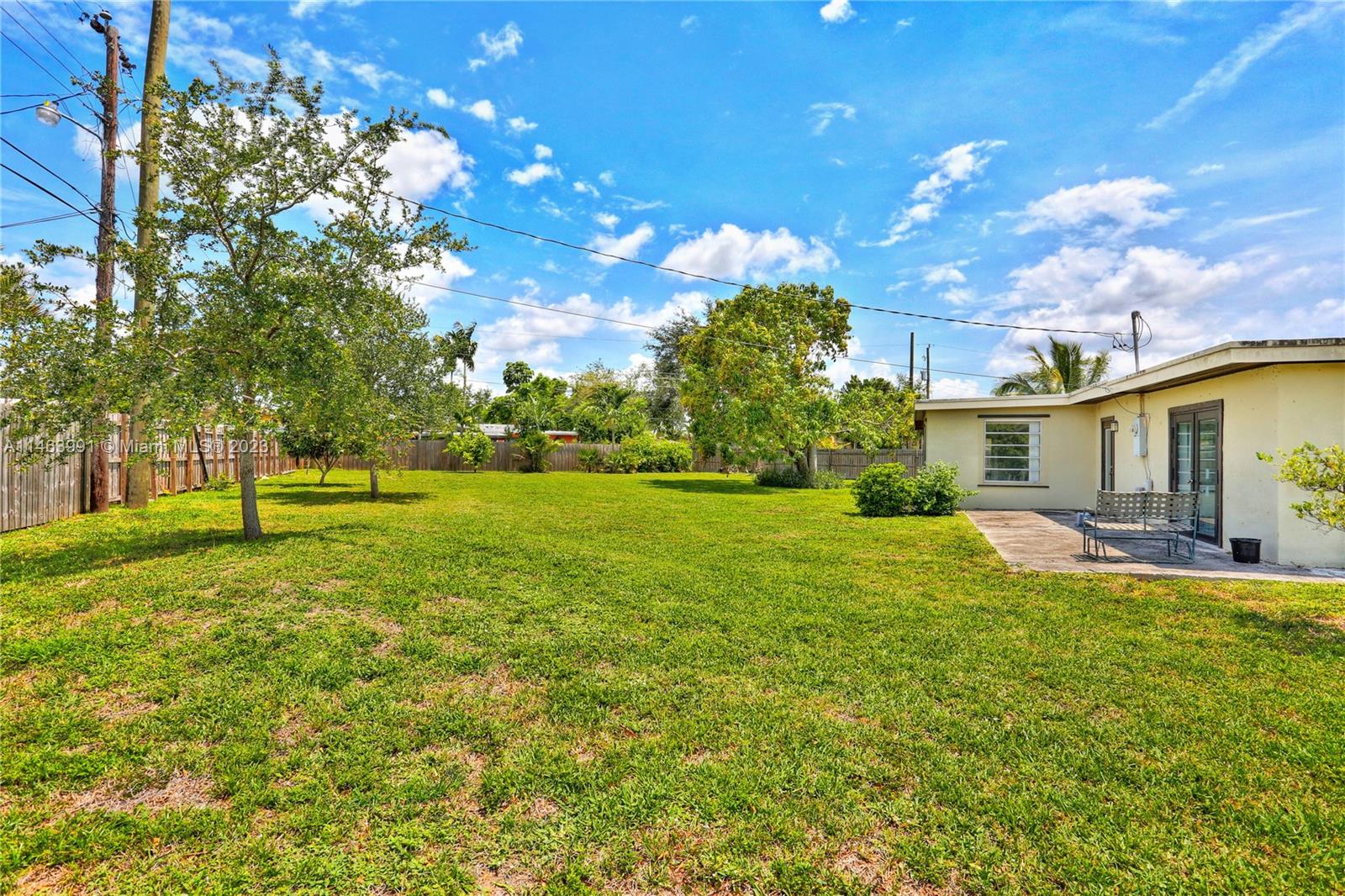10045 Southwest 82nd Street Miami, FL 33173 - Photo 9 of 31 a view of a house with a big yard and sitting area