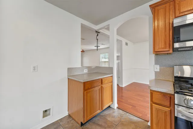 a kitchen with stainless steel appliances a refrigerator and a stove