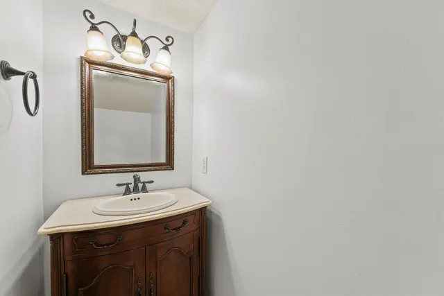 a bathroom with a sink vanity and mirror