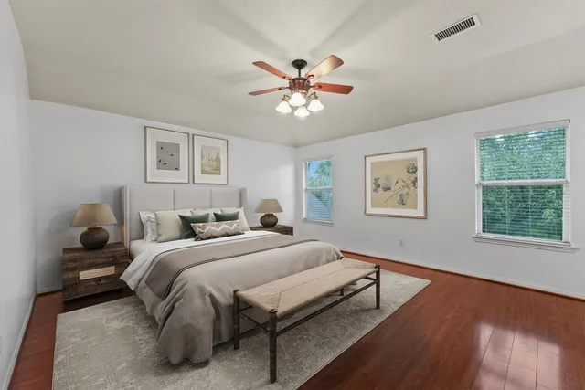 a bedroom with a bed and a chandelier