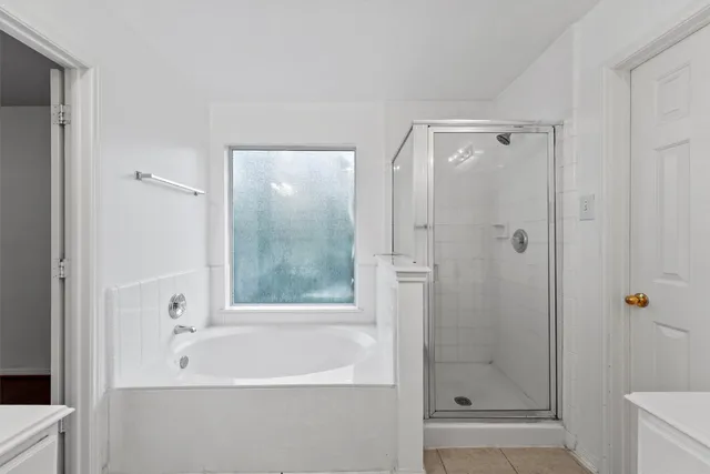 a bathroom with a bathtub and a shower