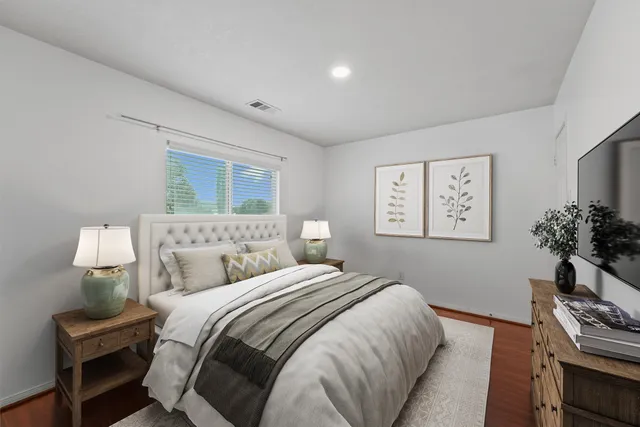 a bedroom with a bed and a flat screen tv