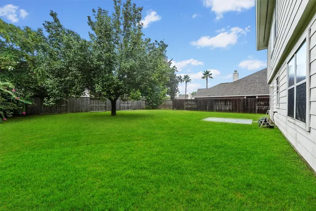 a view of yard with swimming pool and green space