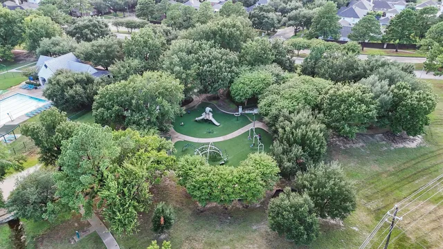 an aerial view of a house with a yard