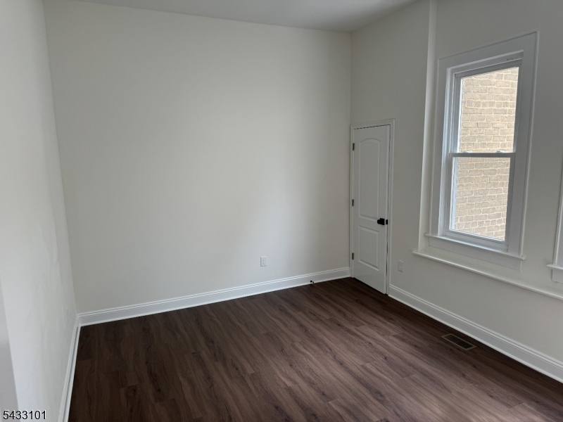 43 1st Avenue, Unit 1 Raritan, NJ 08869 - Photo 4 of 4 an empty room with wooden floor and windows