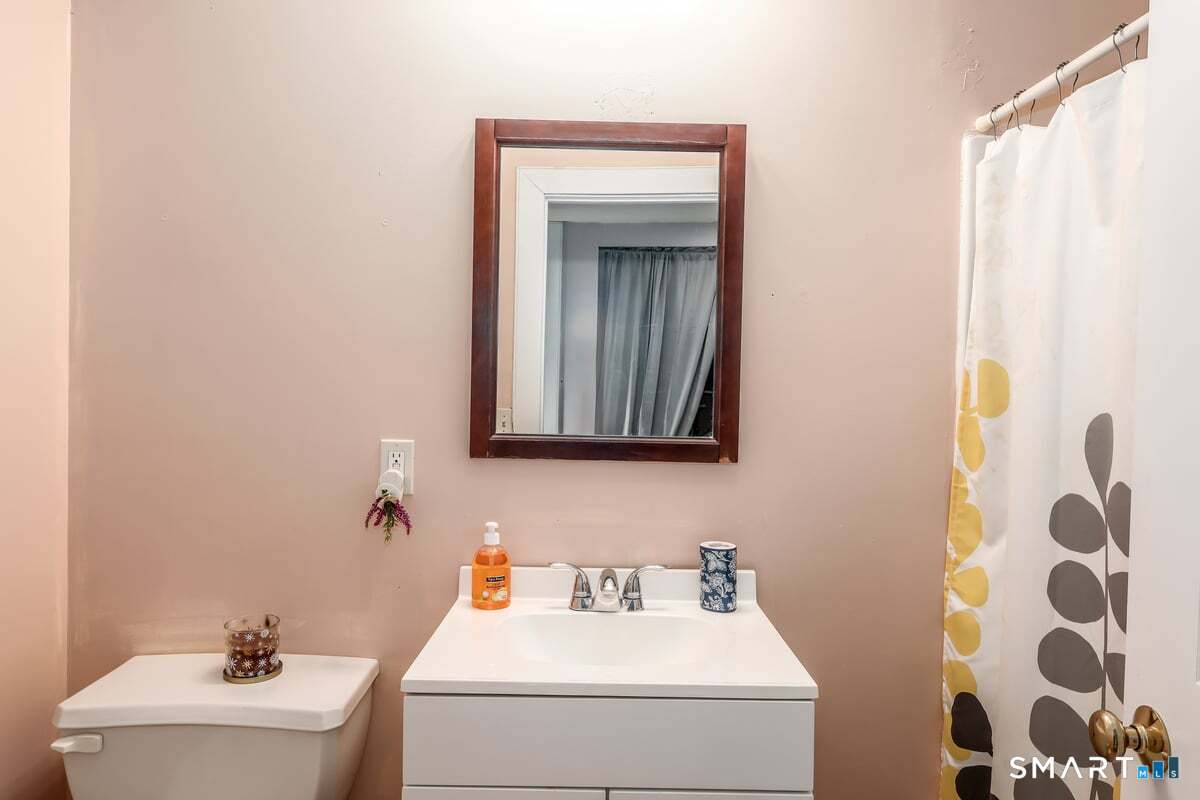 70 Dodgingtown Road Bethel, CT 06801 - Photo 14 of 27 a bathroom with a sink and a mirror