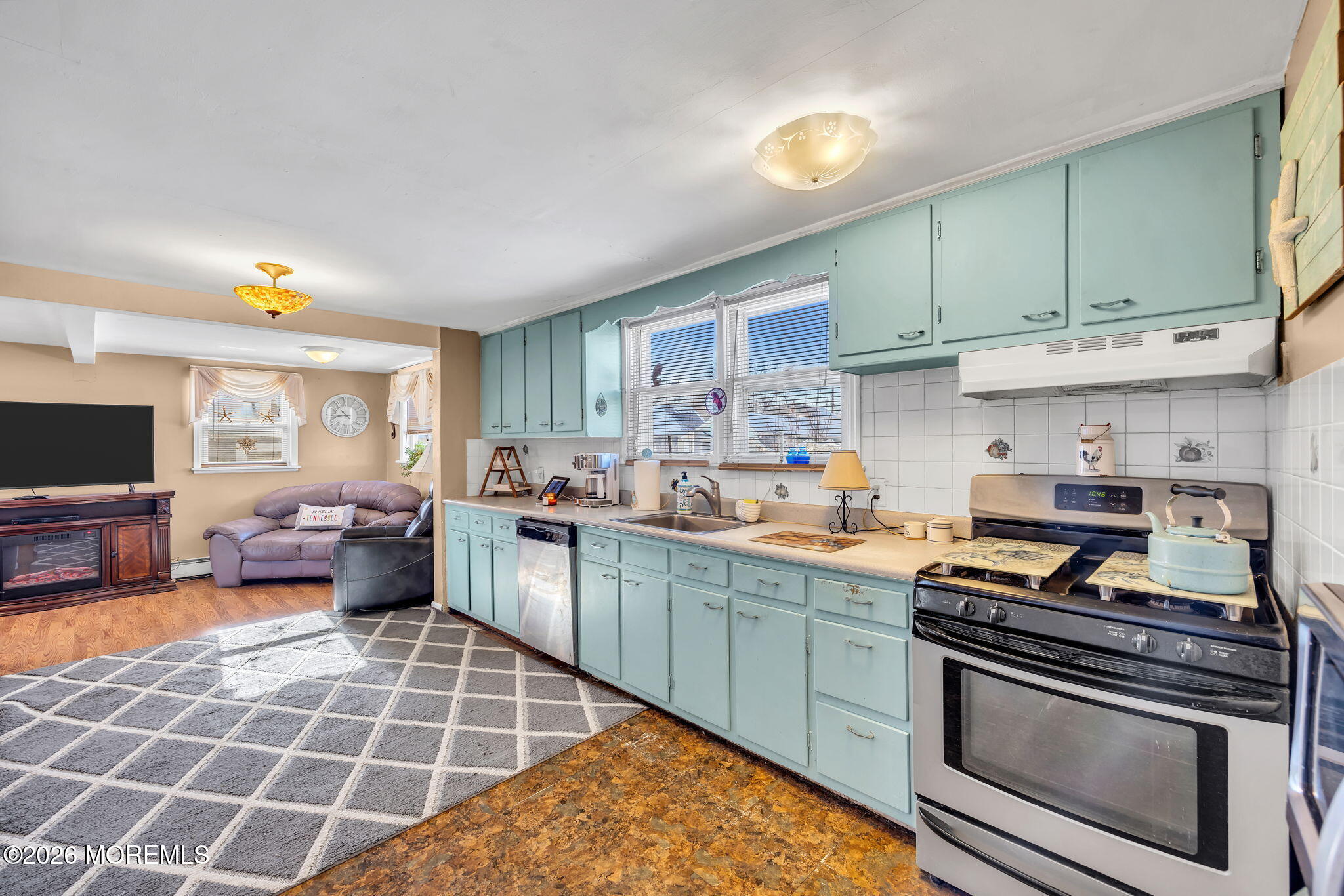 265 Thompson Avenue Middletown, NJ 07748 - Photo 10 of 35 a kitchen with a stove a sink and a refrigerator